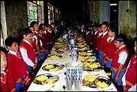 Grace is said at the start of the meal, with the boys dutifully standing at their dining tables... despite the 
food staring invitingly at them!