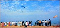 Is it a bird or is it a plane... no, its man flying! Curious visitors watch a hang-gliding class in progress at Harrisons Folly situated on a jutting land mass three kilometres from the check-post of Panchgani on the way to Wai. Inset, Andre Savard, a Canadian national and promoter of adventure sports.