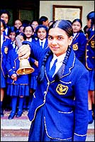 The head girl demonstrates the call bell system for teachers when they are in the staff parlour and behind shut doors... it is an intricate system that only the girls understand and the nuns follow. Read the bell-board below.