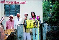 Farzana Contractor drawing water from the Panchgani well outside the market and reliving childhood memories with old kawad-walla friends.