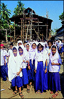 An excursion of curious school-children watch how a dhow is built at the Beypore ship-building yard.