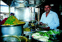 Ashokbhai Champaklal Khamanwala 
making a plate of his famous Raswala Khaman.